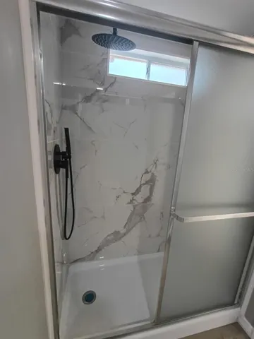 a view of a swimming pool with a patio and a yard