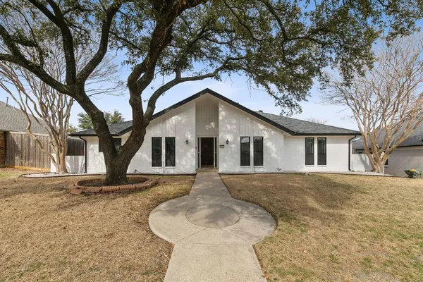 a front view of house with yard and trees