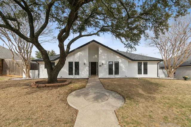 a front view of house with yard and trees
