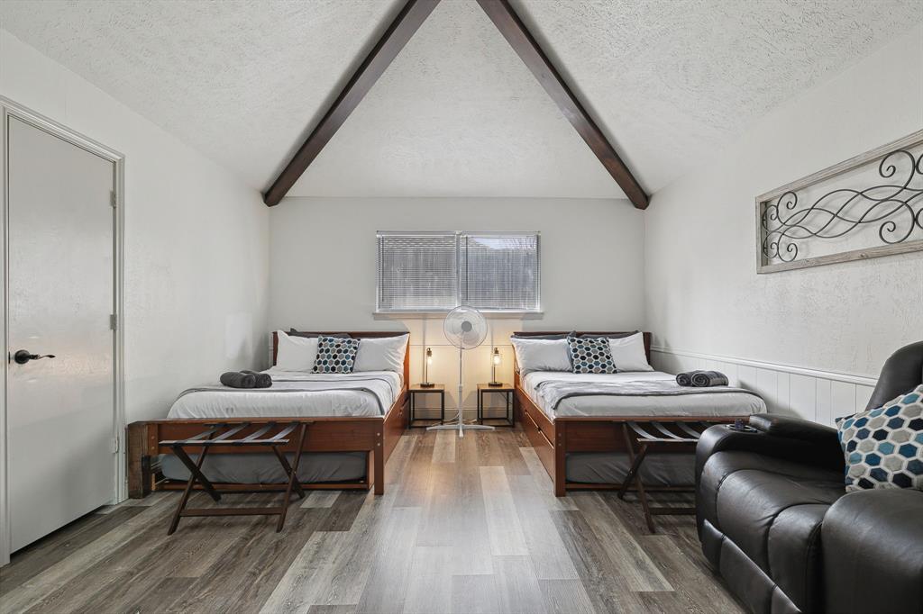 1813 Cross Bend Road Plano, TX 75023 - Photo 13 of 30 Bedroom featuring a textured ceiling and wood finished floors