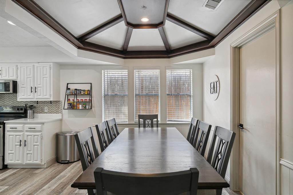 1813 Cross Bend Road Plano, TX 75023 - Photo 15 of 30 a view of a dining room with furniture and wooden floor