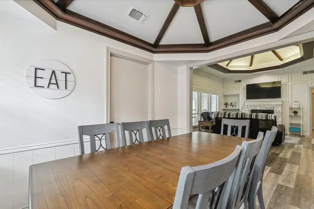 a kitchen with a refrigerator a sink a stove and white cabinets