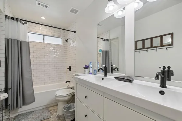 a view of walk in closet with clothes