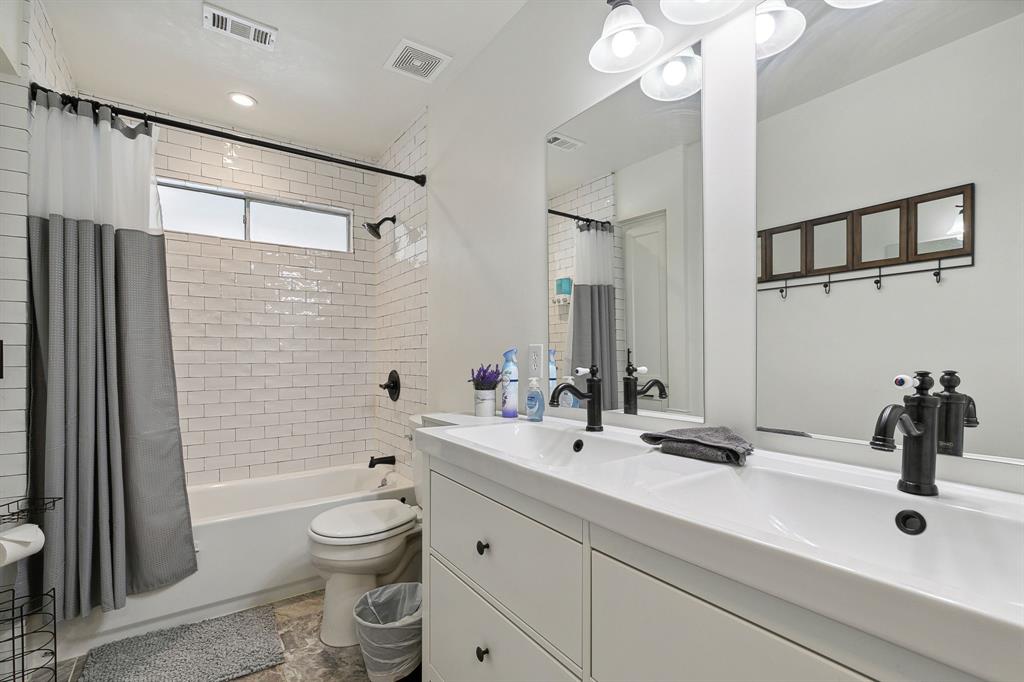 1813 Cross Bend Road Plano, TX 75023 - Photo 19 of 30 a bathroom with a sink a toilet a mirror and shower