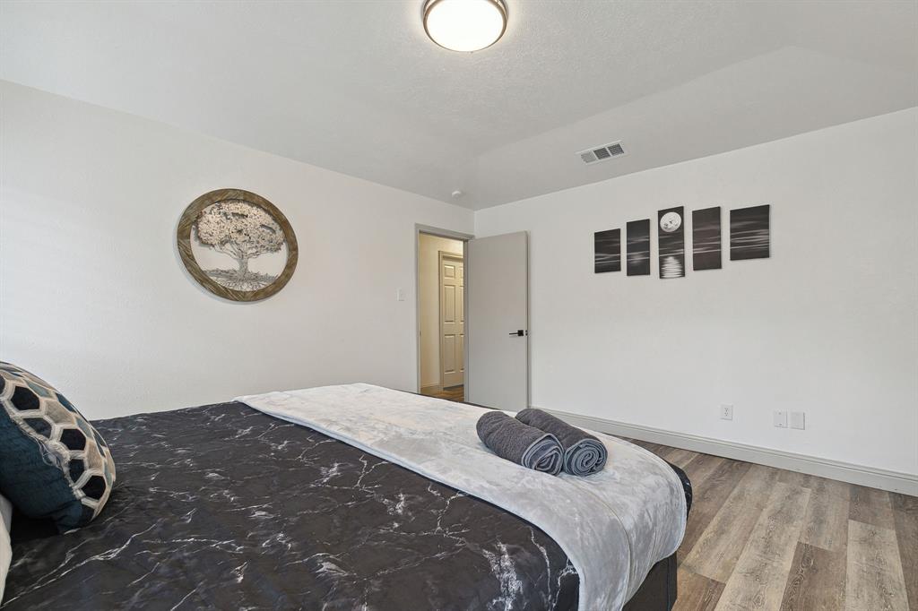 1813 Cross Bend Road Plano, TX 75023 - Photo 22 of 30 Bedroom with wood finished floors and baseboards