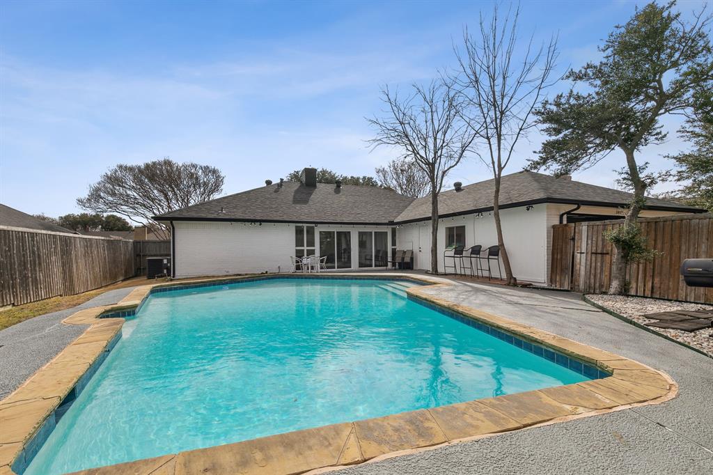 1813 Cross Bend Road Plano, TX 75023 - Photo 3 of 30 View of pool with a fenced backyard, a patio area, and a sunroom