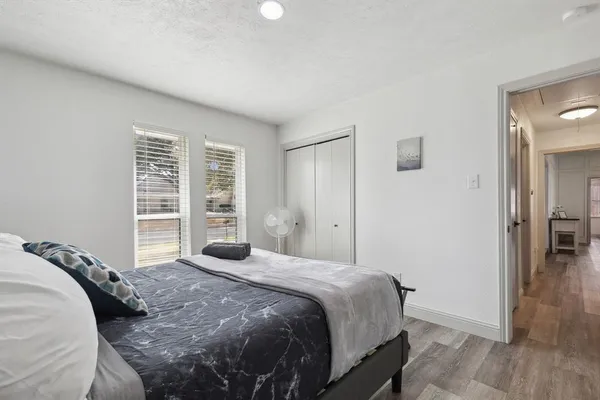 a bedroom with a bed and wooden floor