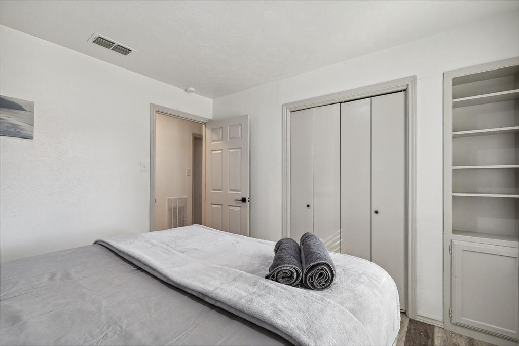 1813 Cross Bend Road Plano, TX 75023 - Photo 8 of 30 a bedroom with a bed and walk in closet