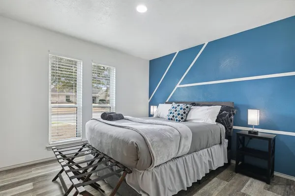 a bedroom with a bed and a window