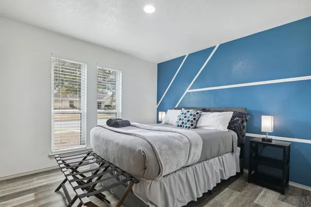 a bedroom with a bed and a window