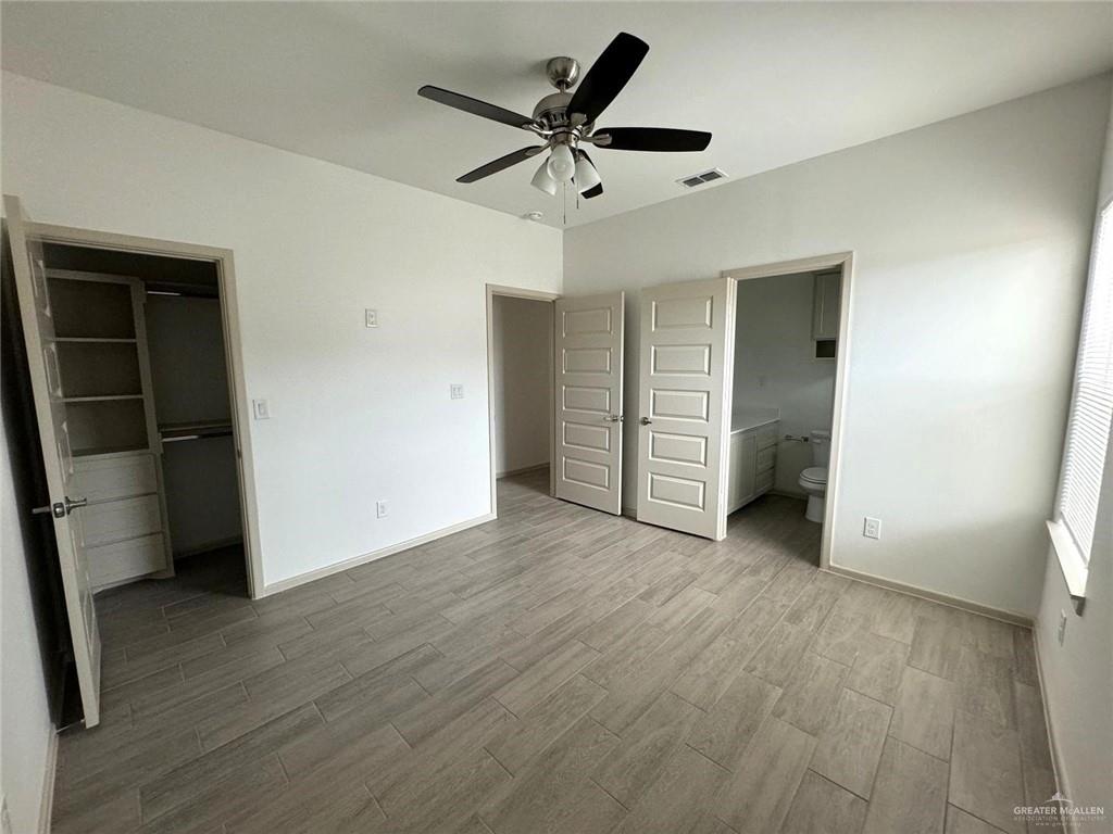 7811 North 58th Street, Unit 3 Mission, TX 78573 - Photo 4 of 11 wooden floor in an empty room with a window