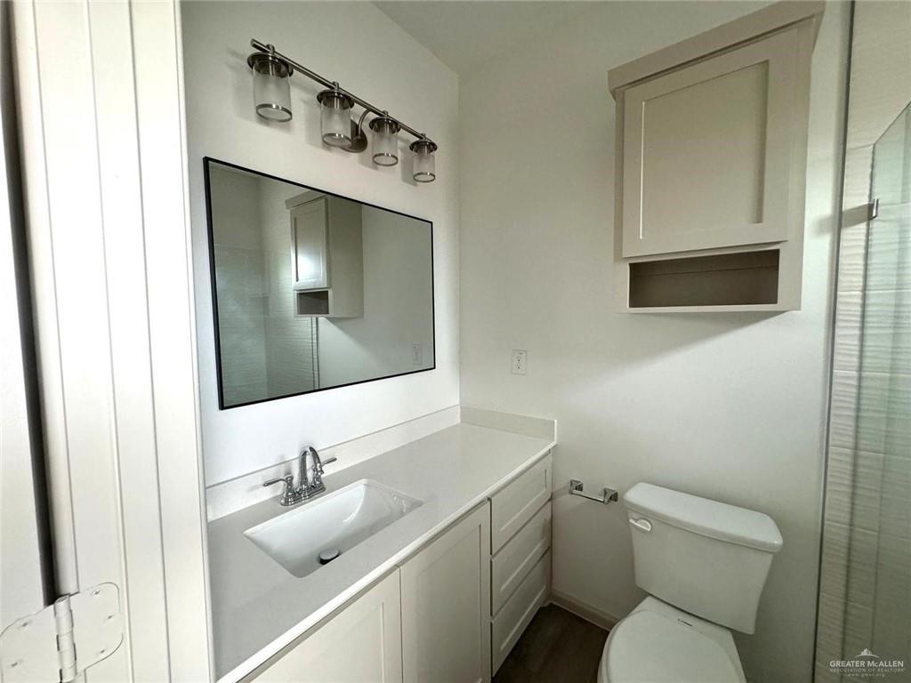 7811 North 58th Street, Unit 3 Mission, TX 78573 - Photo 7 of 11 a bathroom with a toilet sink and mirror