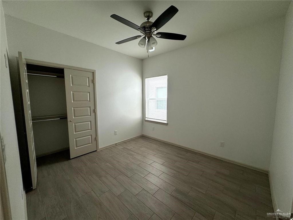 7811 North 58th Street, Unit 3 Mission, TX 78573 - Photo 8 of 11 an empty room with a window and a ceiling fan