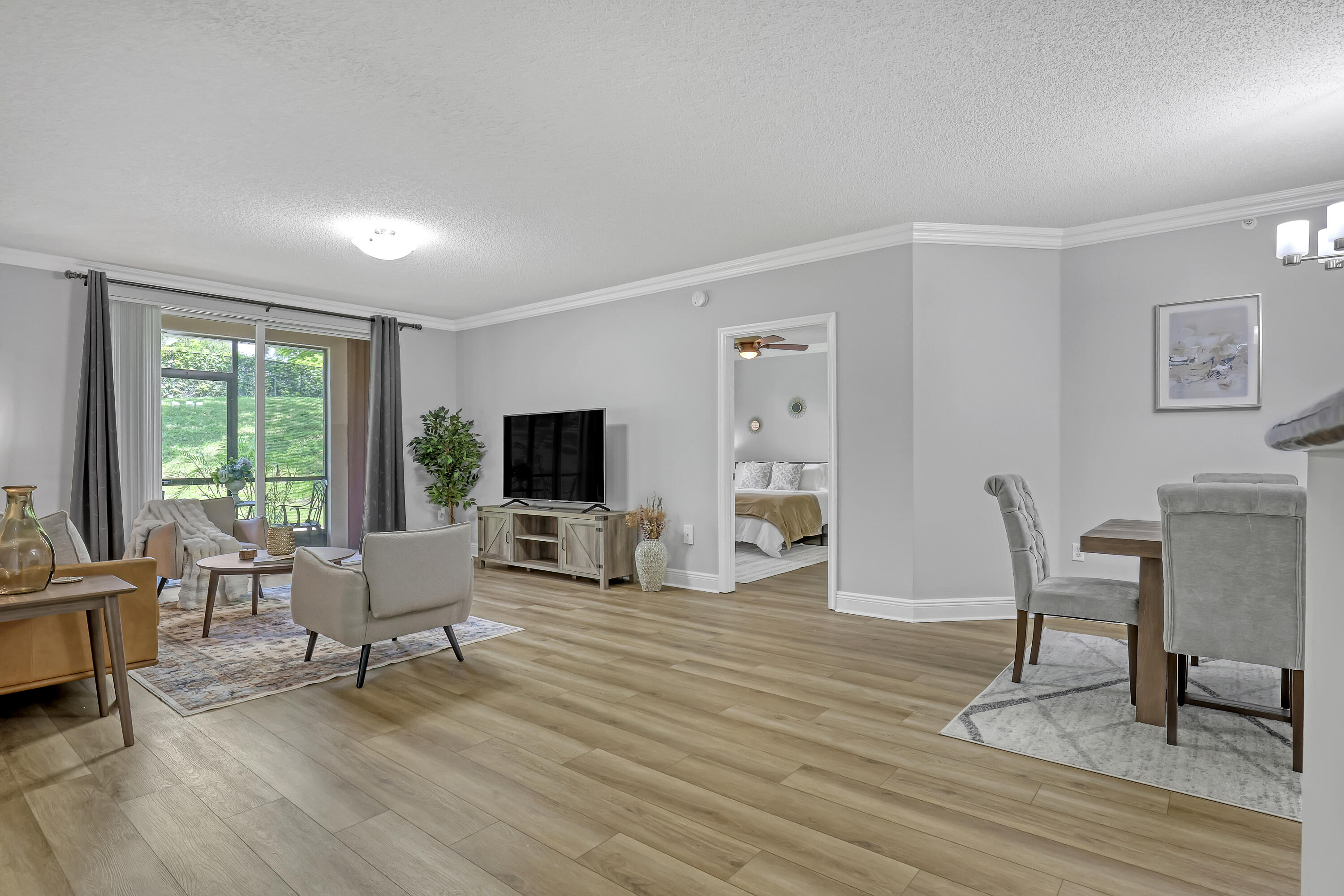 11790 St Andrews Place, Unit 105 Wellington, FL 33414 - Photo 13 of 55 a living room with furniture and a flat screen tv