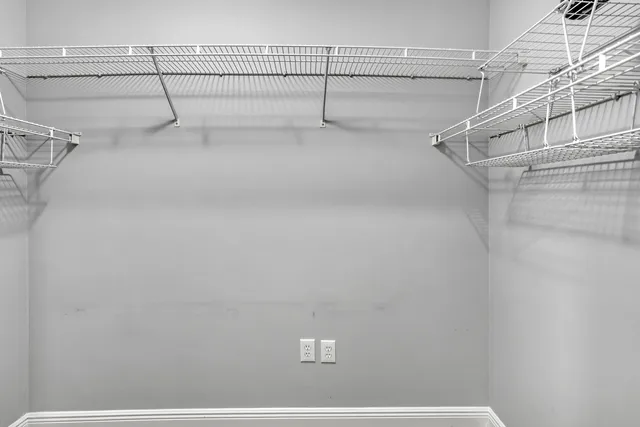 a bathroom with a granite countertop sink a toilet a mirror and shower