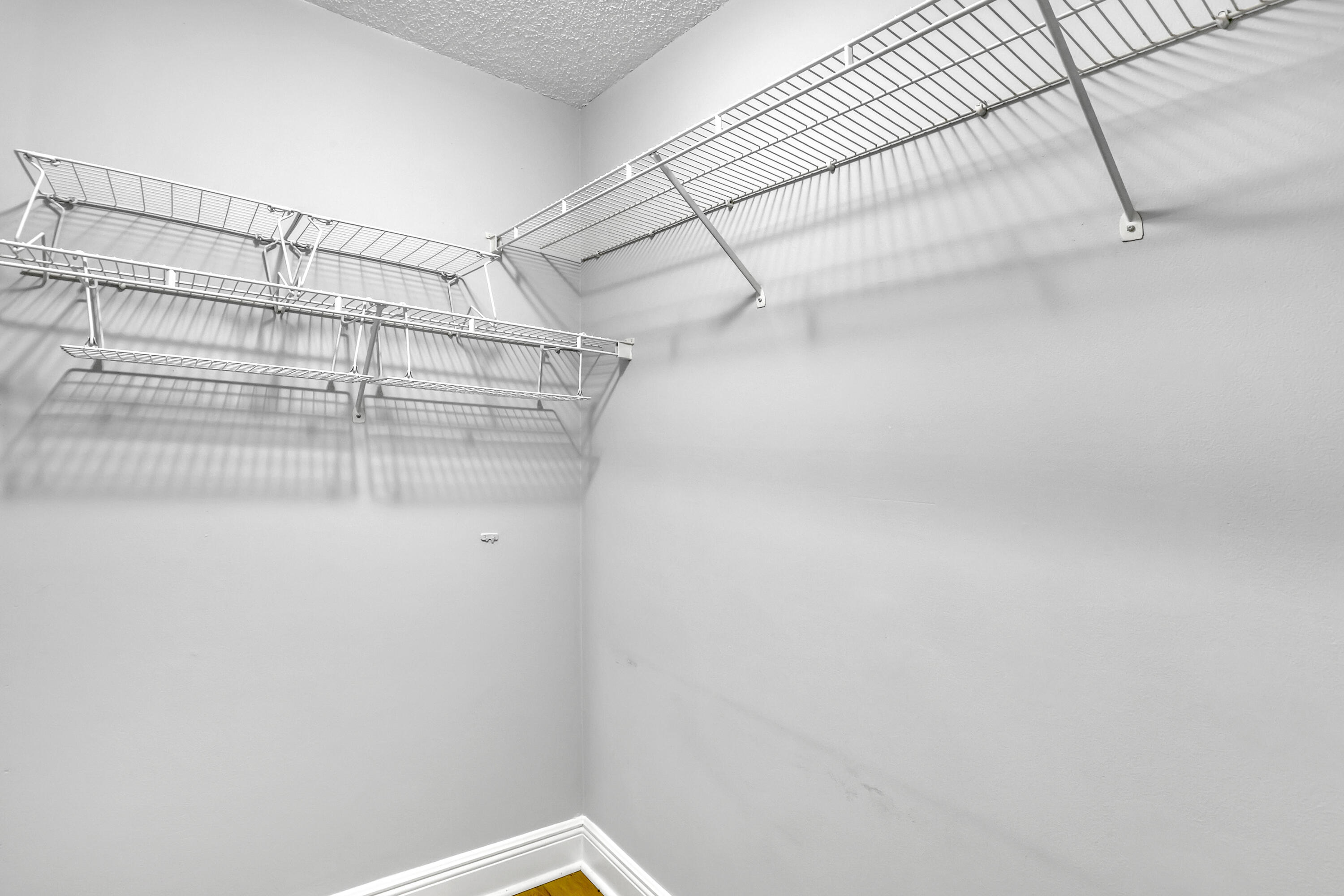 11790 St Andrews Place, Unit 105 Wellington, FL 33414 - Photo 19 of 55 a view of a room with racks on the wall