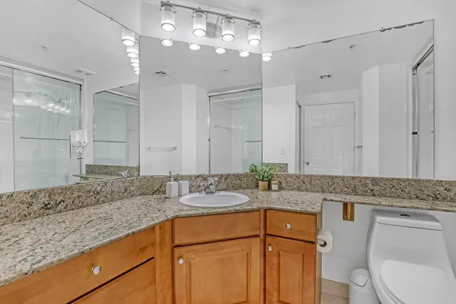 a bedroom with two beds and a potted plant