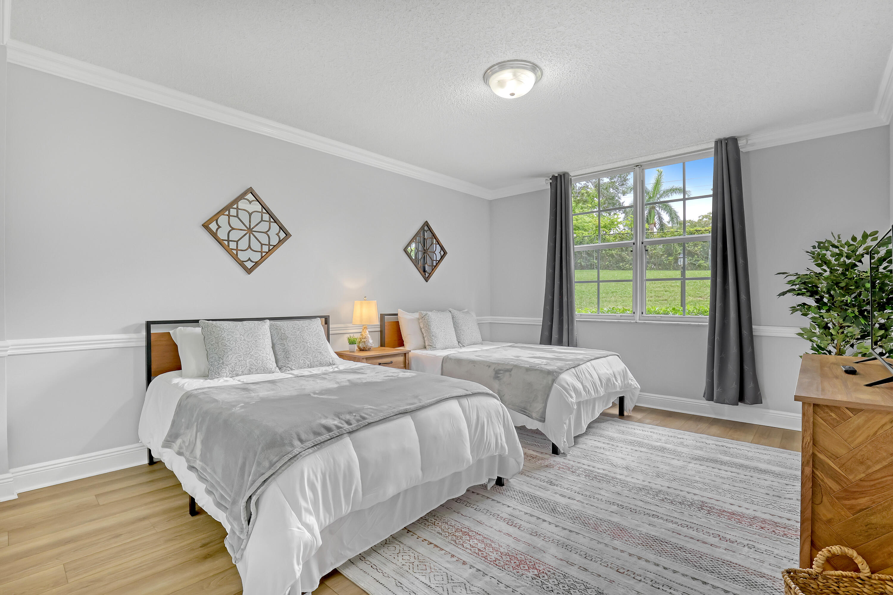 11790 St Andrews Place, Unit 105 Wellington, FL 33414 - Photo 22 of 55 a bedroom with two beds and a potted plant