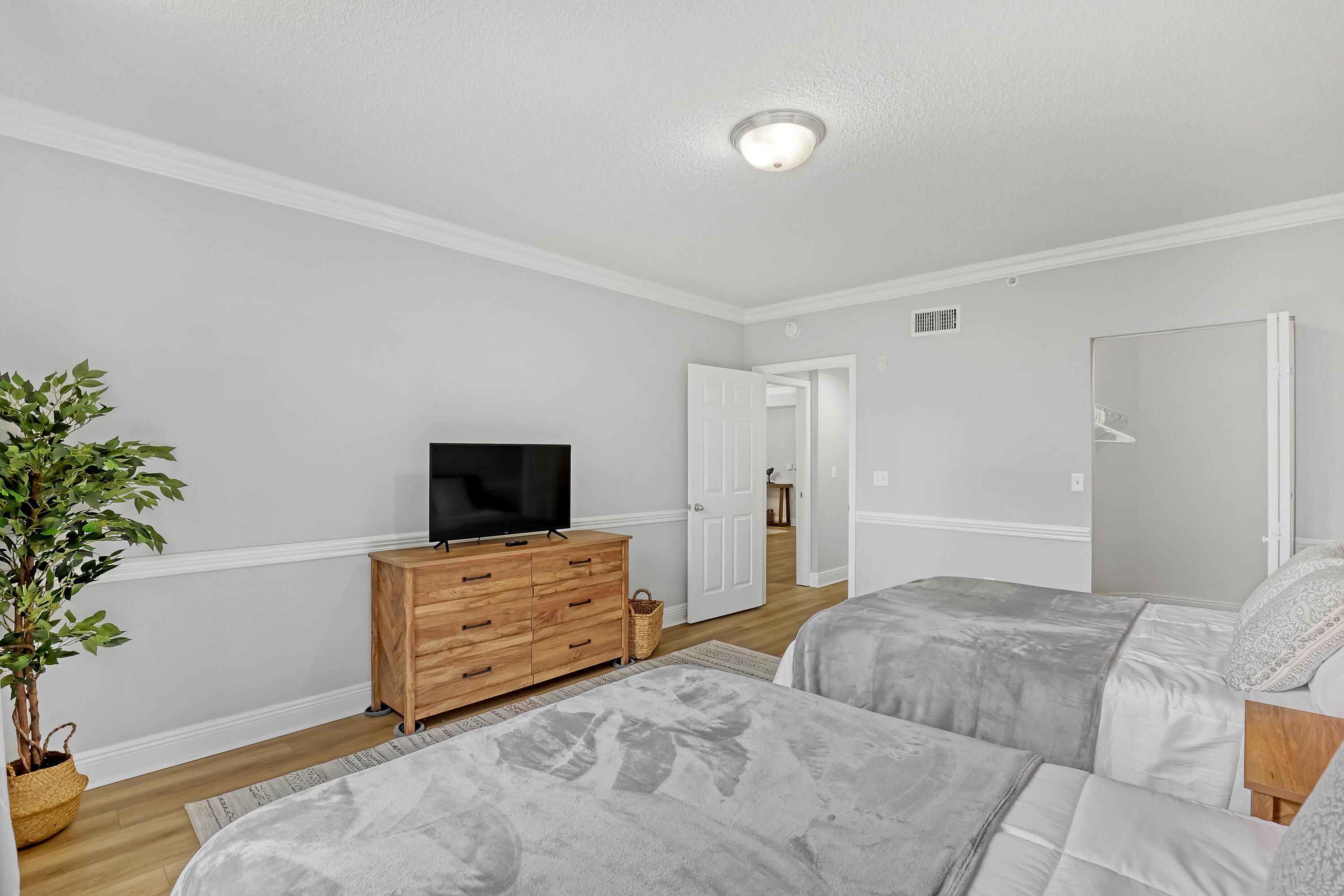 11790 St Andrews Place, Unit 105 Wellington, FL 33414 - Photo 23 of 55 a bedroom with a bed and a potted plant