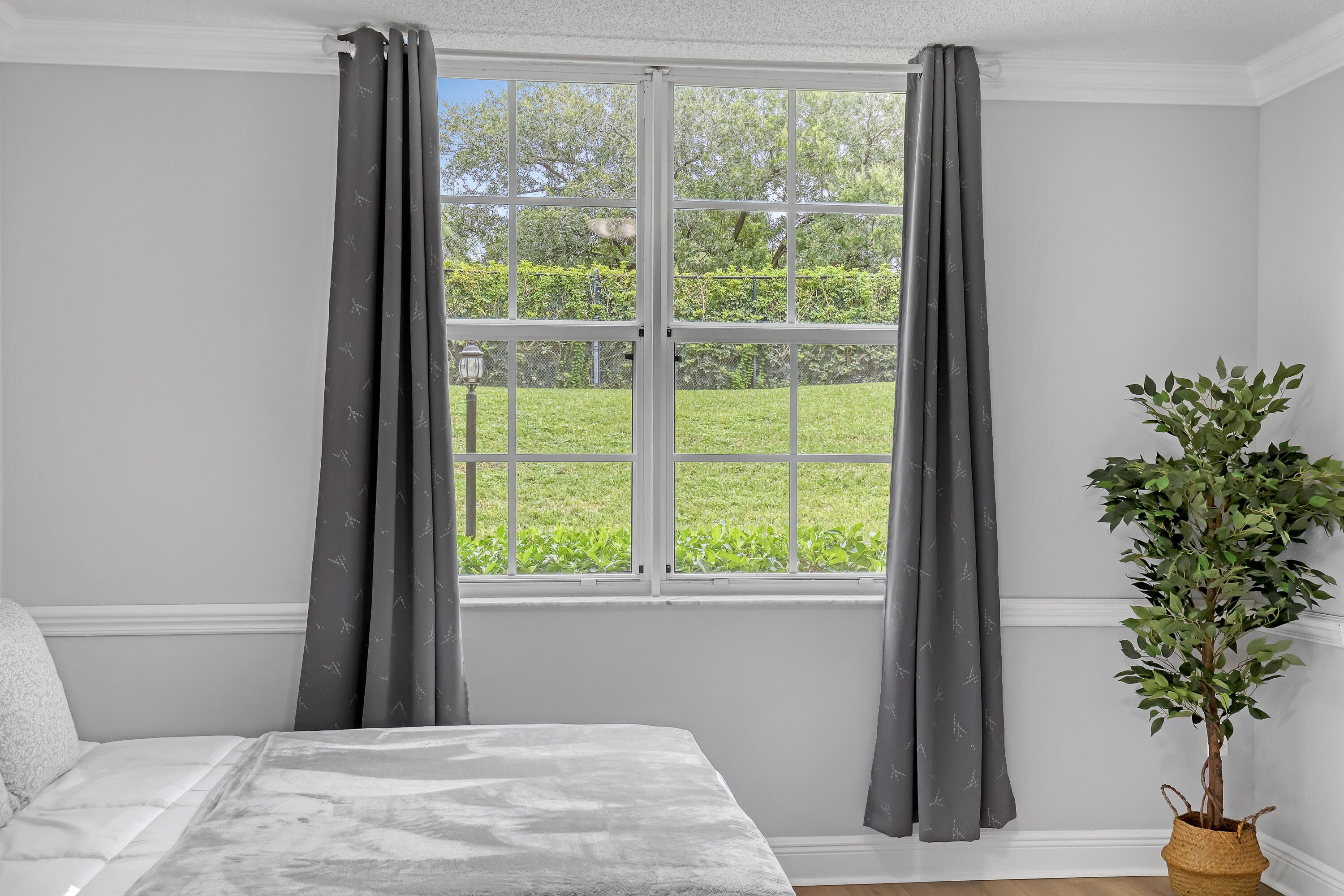 11790 St Andrews Place, Unit 105 Wellington, FL 33414 - Photo 24 of 55 a bedroom with a bed and a window