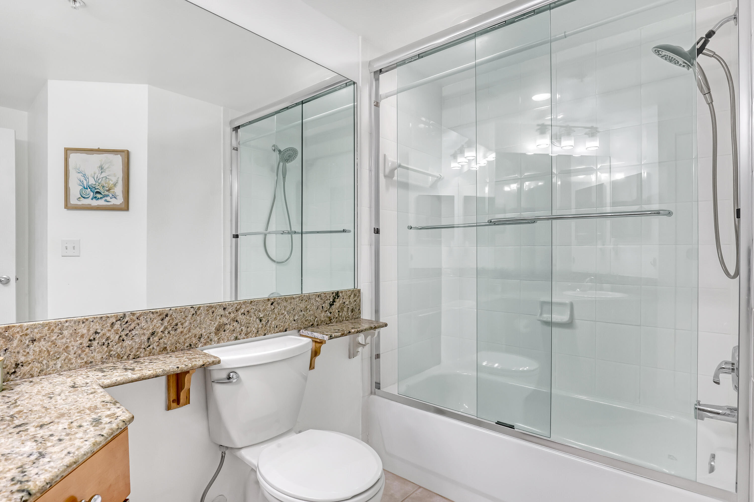 11790 St Andrews Place, Unit 105 Wellington, FL 33414 - Photo 27 of 55 a bathroom with a granite countertop sink toilet and shower