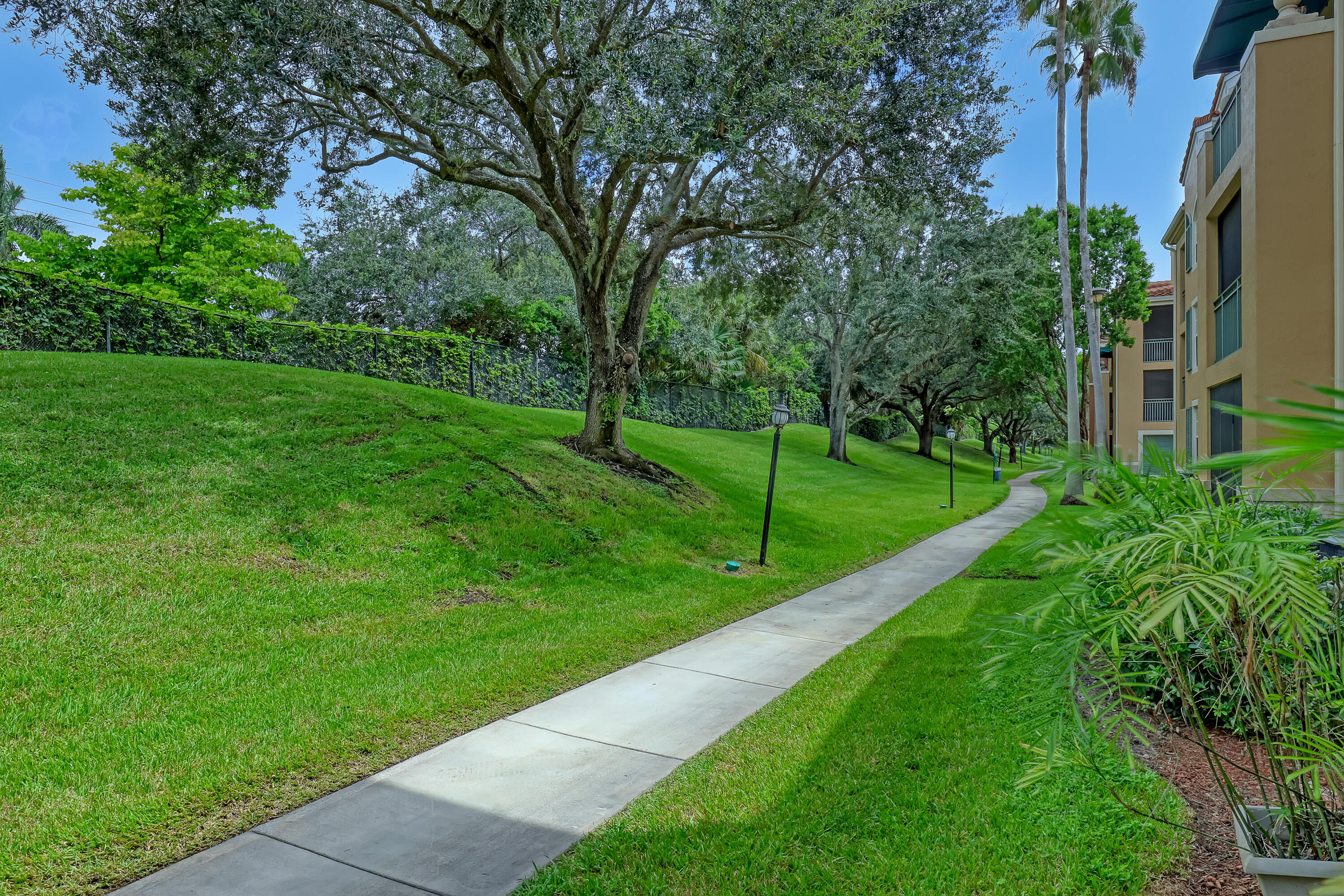 11790 St Andrews Place, Unit 105 Wellington, FL 33414 - Photo 34 of 55 a view of a park with large trees