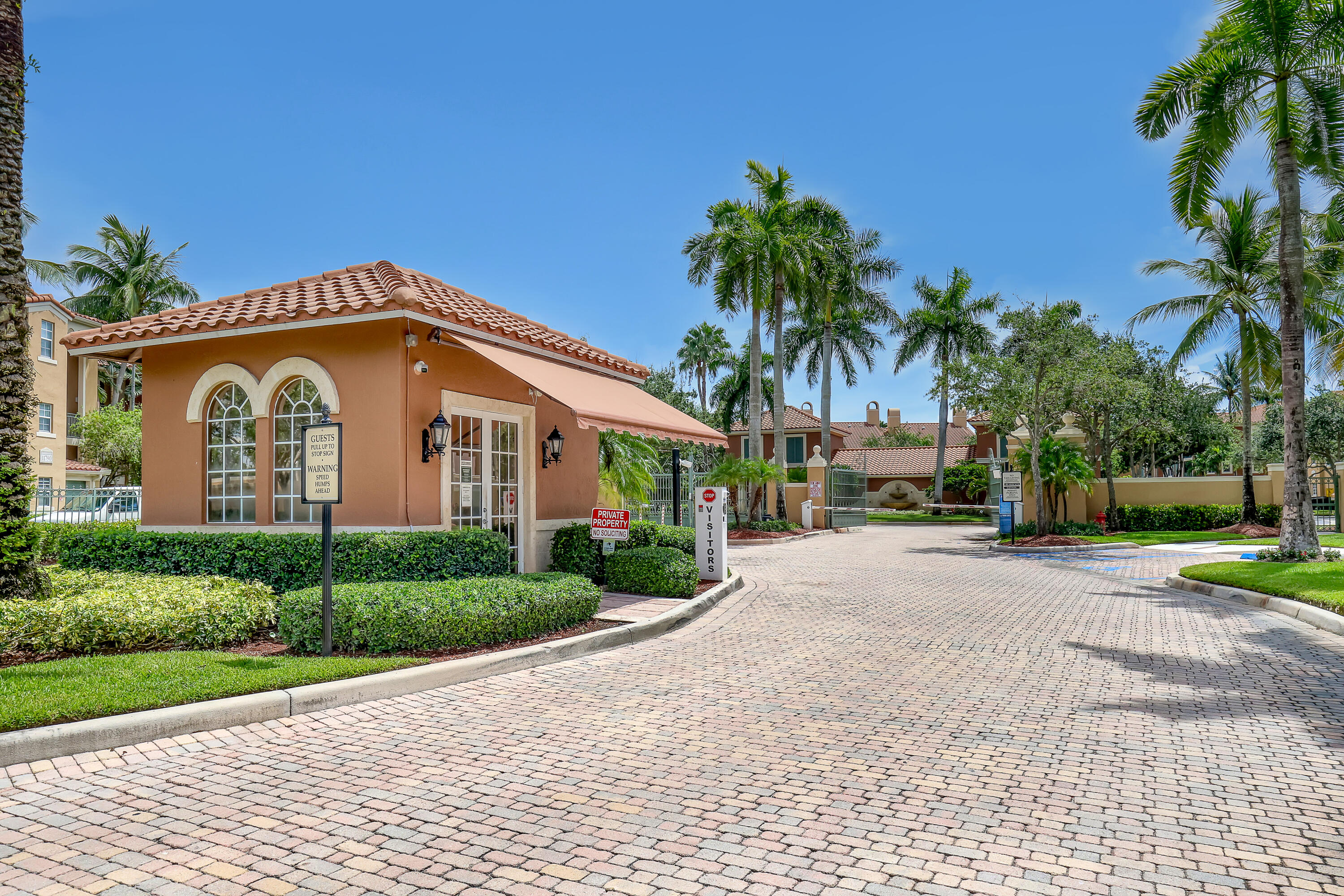 11790 St Andrews Place, Unit 105 Wellington, FL 33414 - Photo 36 of 55 a view of a house with a yard and palm trees