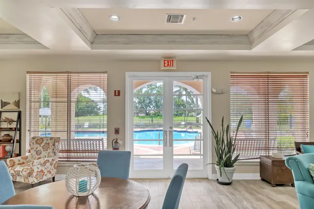 a front view of a house with a yard and potted plants