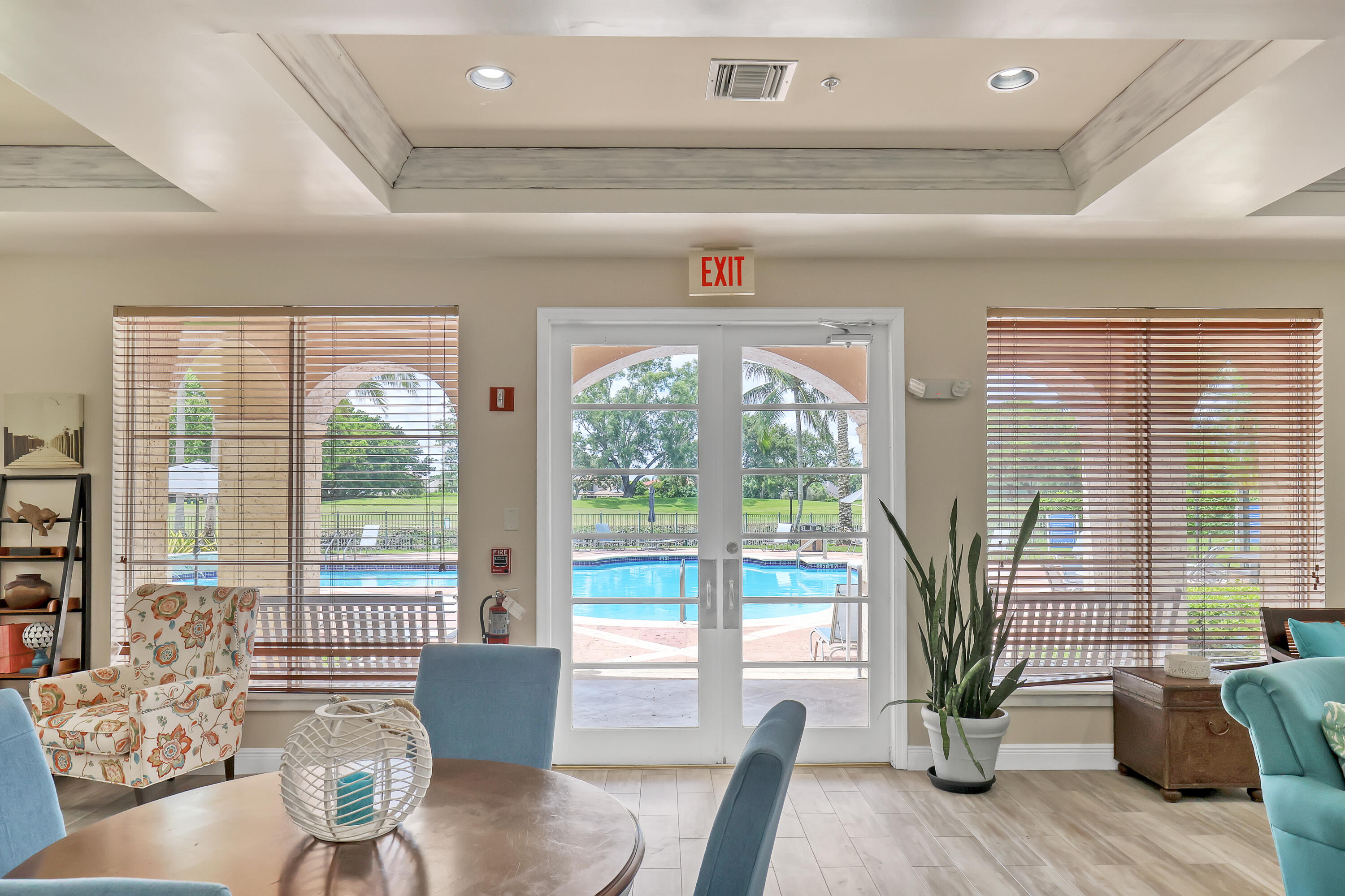 11790 St Andrews Place, Unit 105 Wellington, FL 33414 - Photo 39 of 55 a living room with furniture and floor to ceiling windows