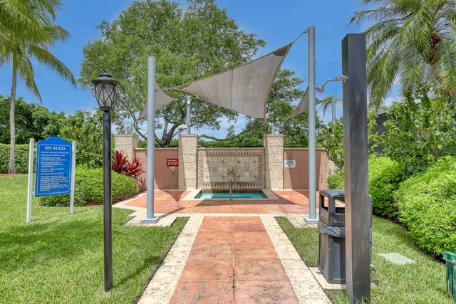 a room with wooden floor pool table and windows