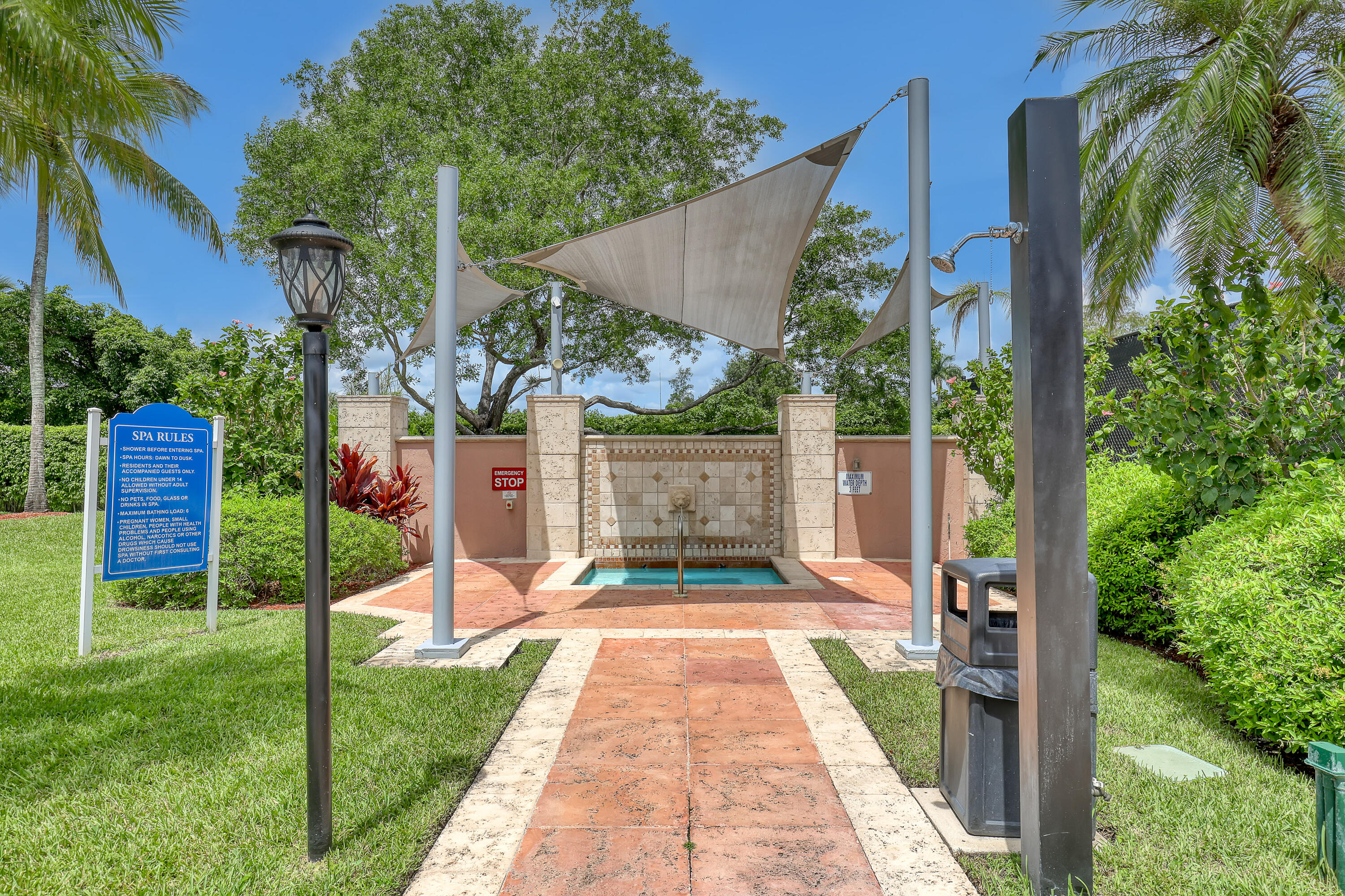 11790 St Andrews Place, Unit 105 Wellington, FL 33414 - Photo 43 of 55 a front view of a house with a yard and potted plants
