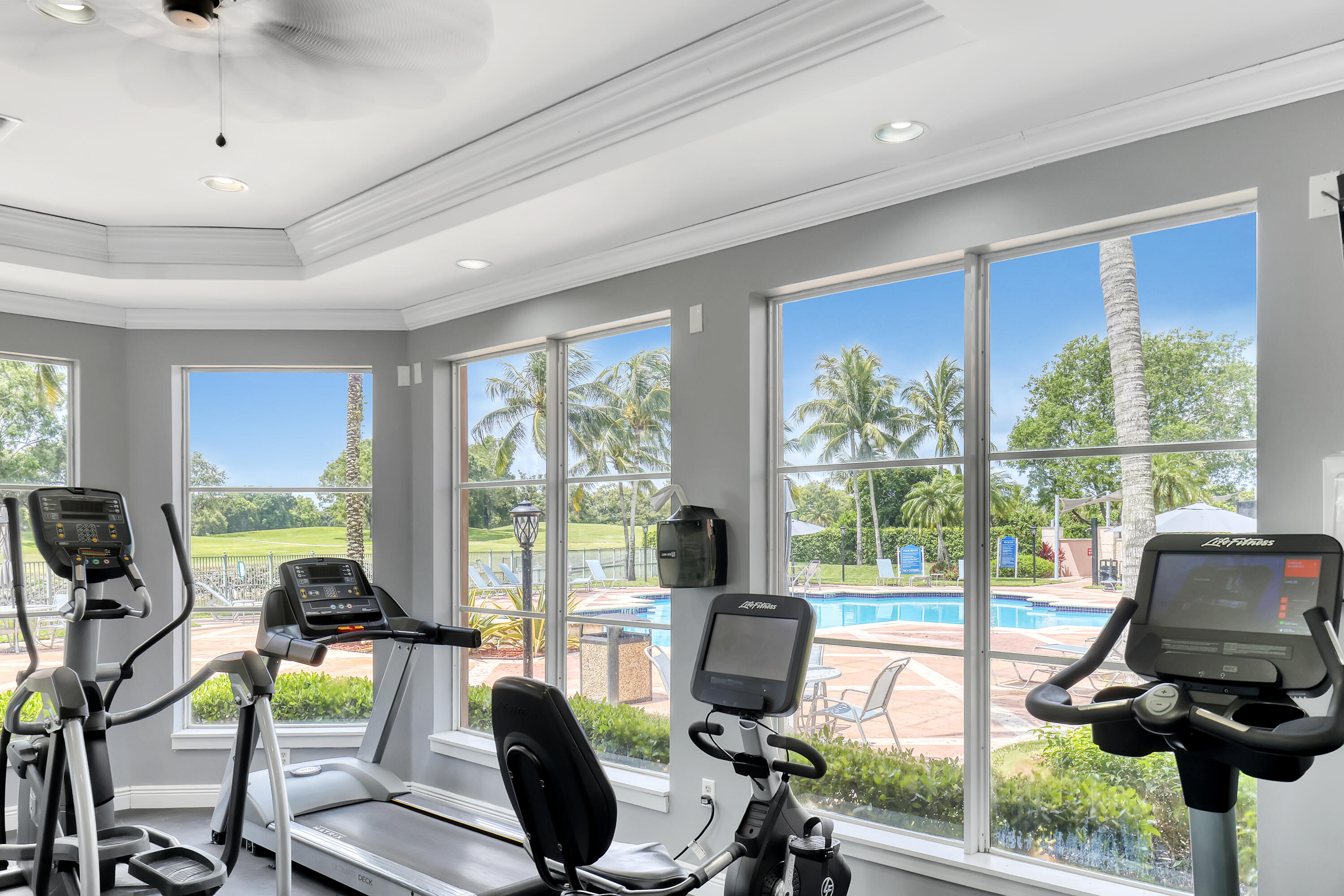 11790 St Andrews Place, Unit 105 Wellington, FL 33414 - Photo 47 of 55 a living room with furniture floor to ceiling window and a flat screen tv