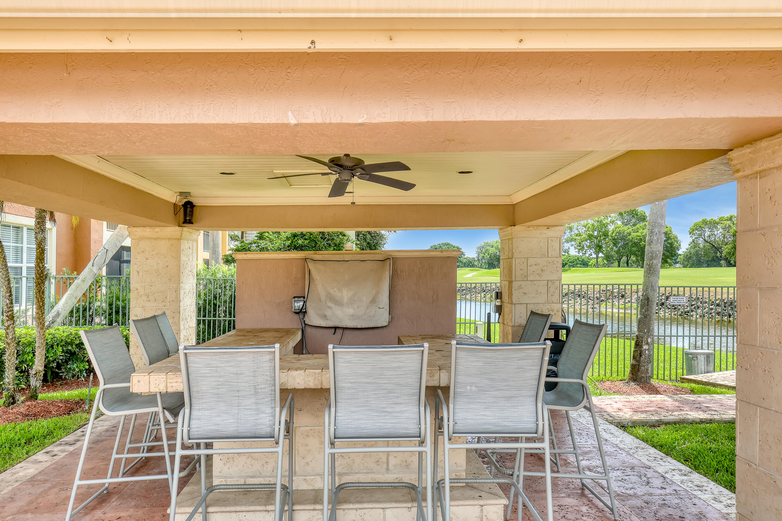 11790 St Andrews Place, Unit 105 Wellington, FL 33414 - Photo 50 of 55 a view of a patio with a table and chairs