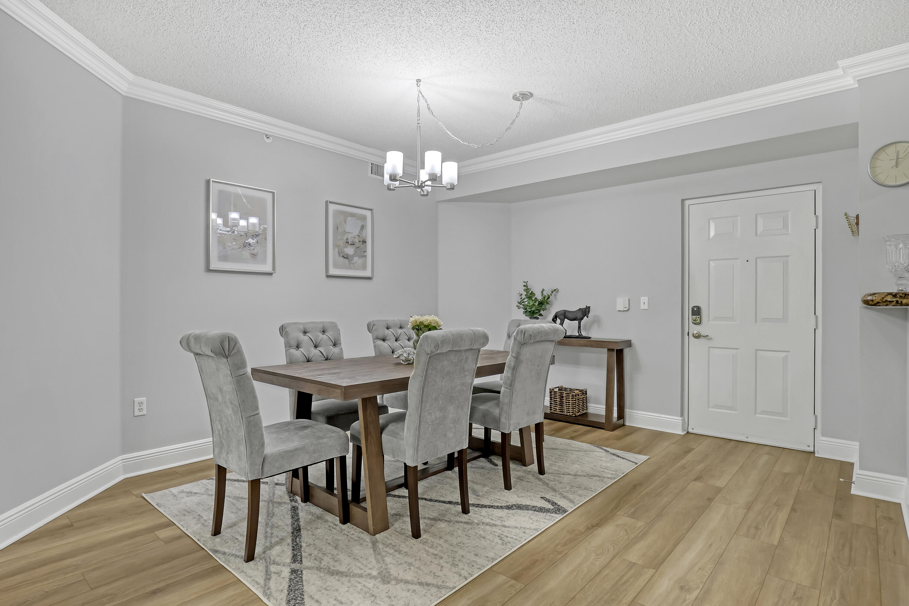 11790 St Andrews Place, Unit 105 Wellington, FL 33414 - Photo 6 of 55 a view of a dining room with furniture and wooden floor