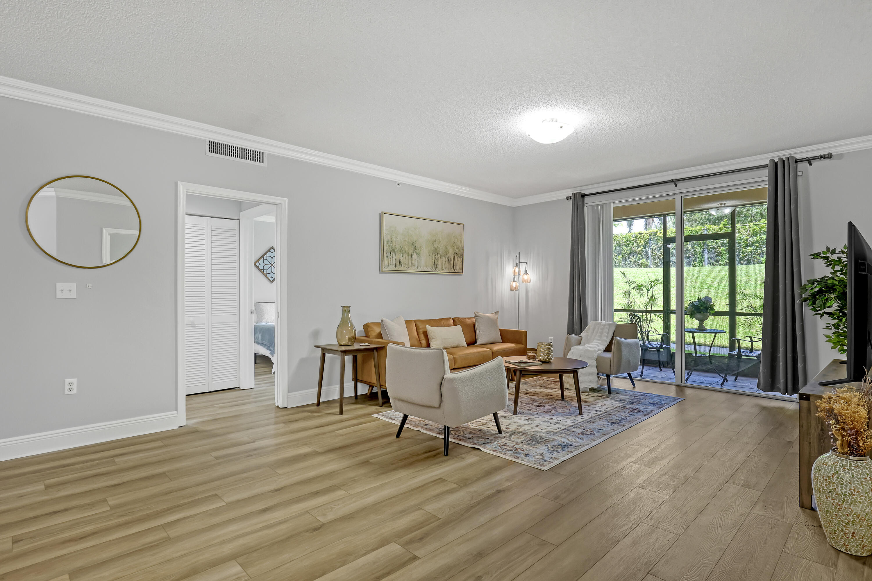11790 St Andrews Place, Unit 105 Wellington, FL 33414 - Photo 7 of 55 a living room with furniture and wooden floor