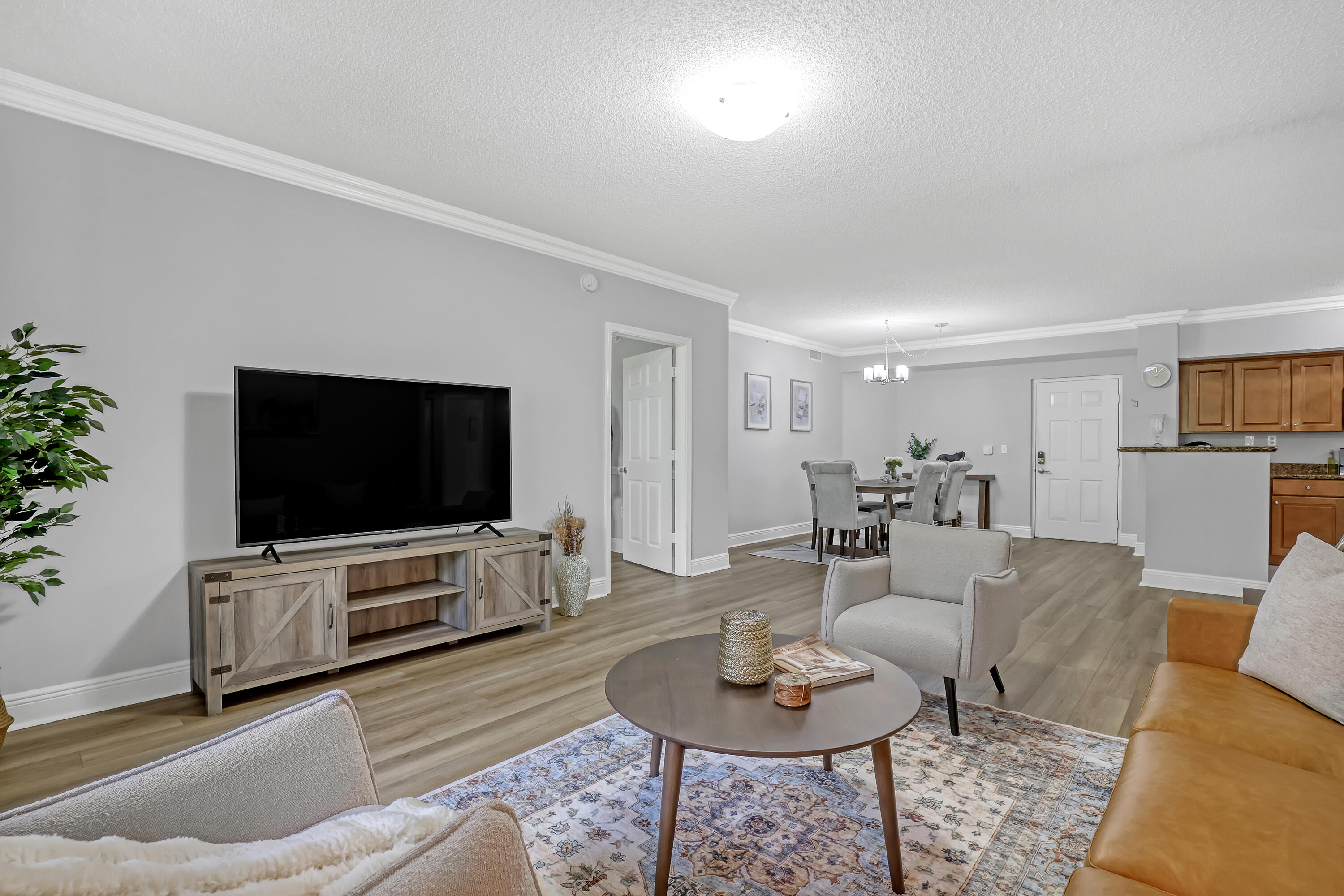 11790 St Andrews Place, Unit 105 Wellington, FL 33414 - Photo 8 of 55 a living room with furniture and a flat screen tv