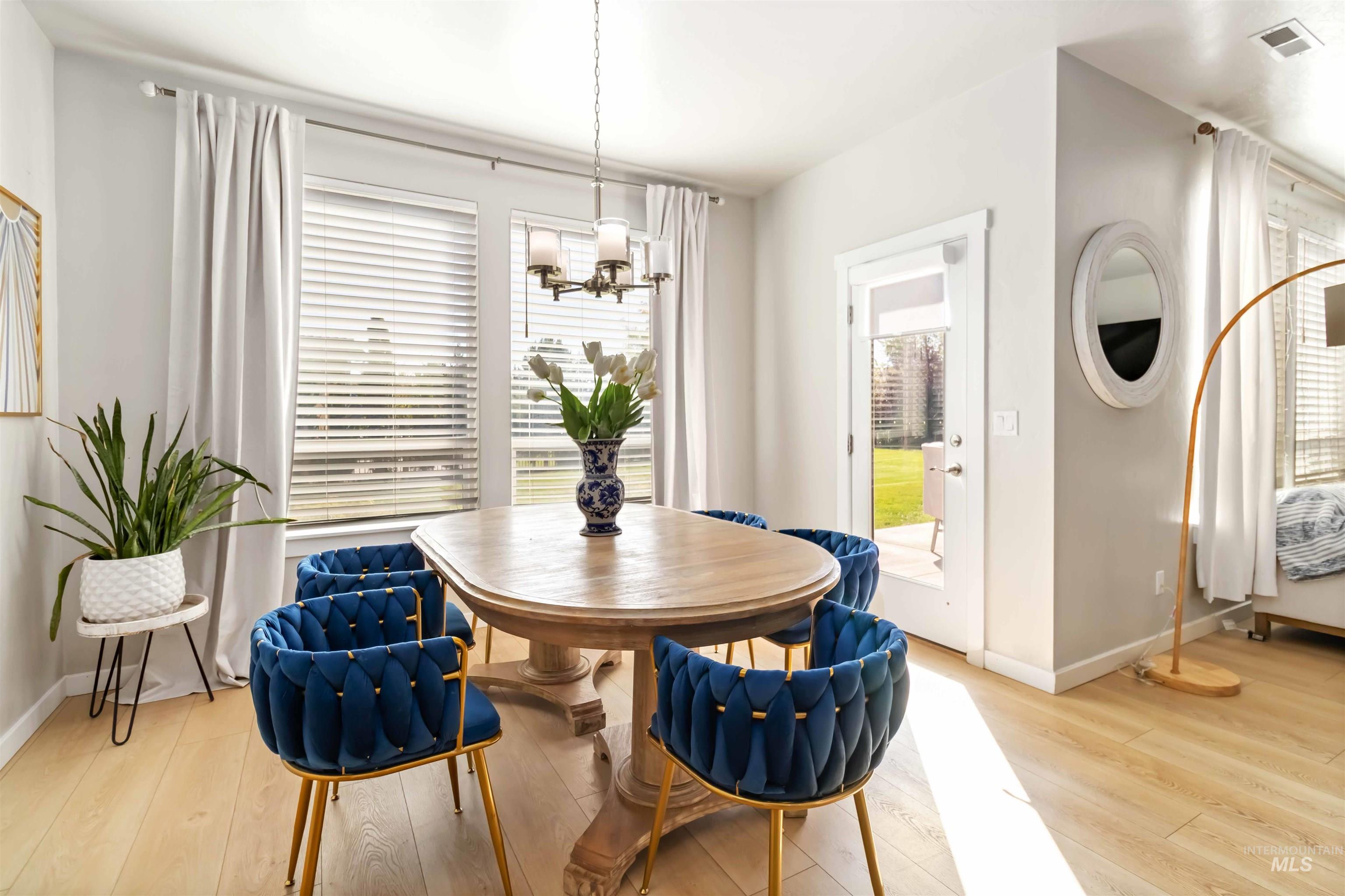 892 North Chastain Lane Eagle, ID 83616 - Photo 13 of 45 Dining room featuring light wood-style floors and a chandelier