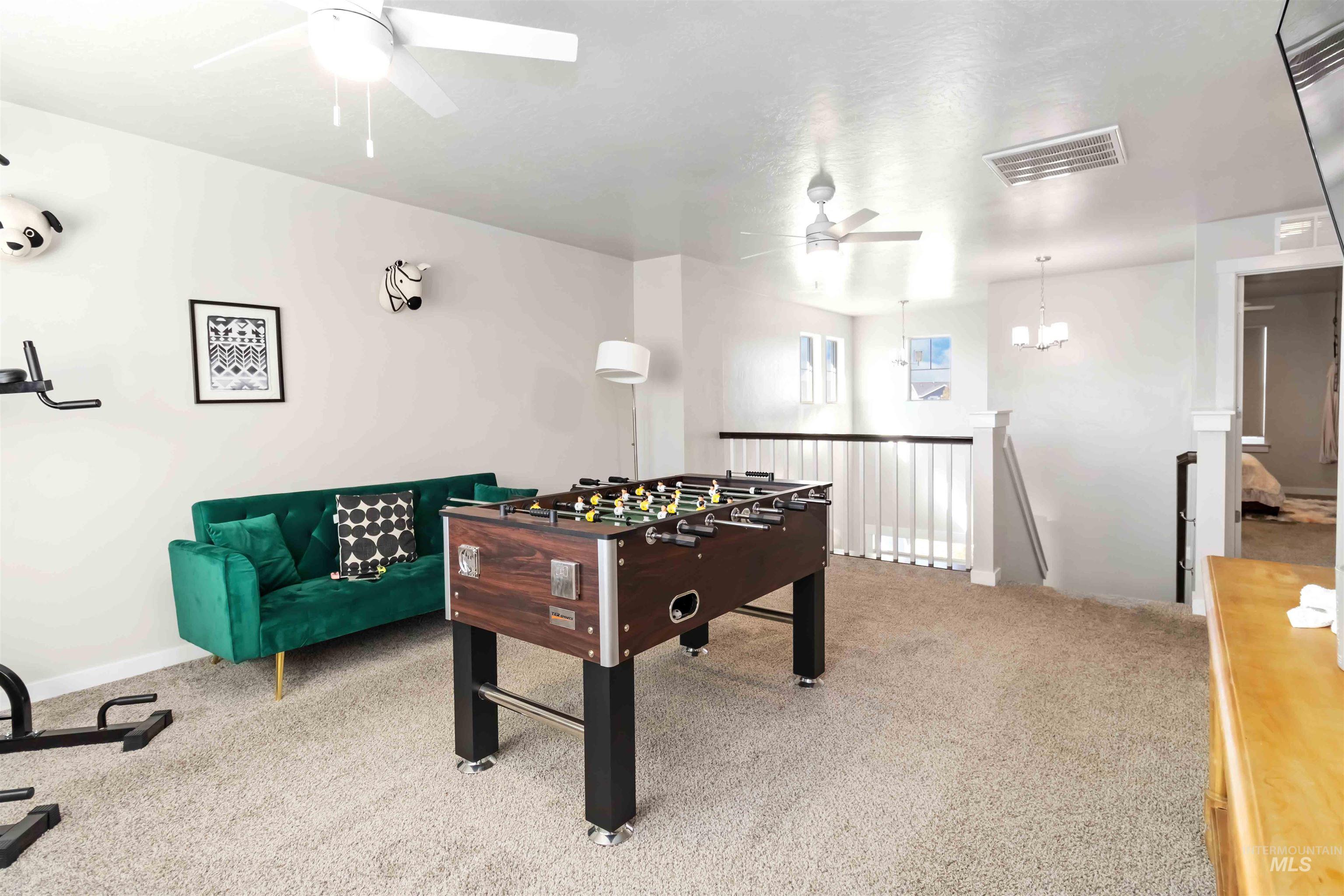 892 North Chastain Lane Eagle, ID 83616 - Photo 28 of 45 Playroom with light colored carpet, a ceiling fan, and a chandelier