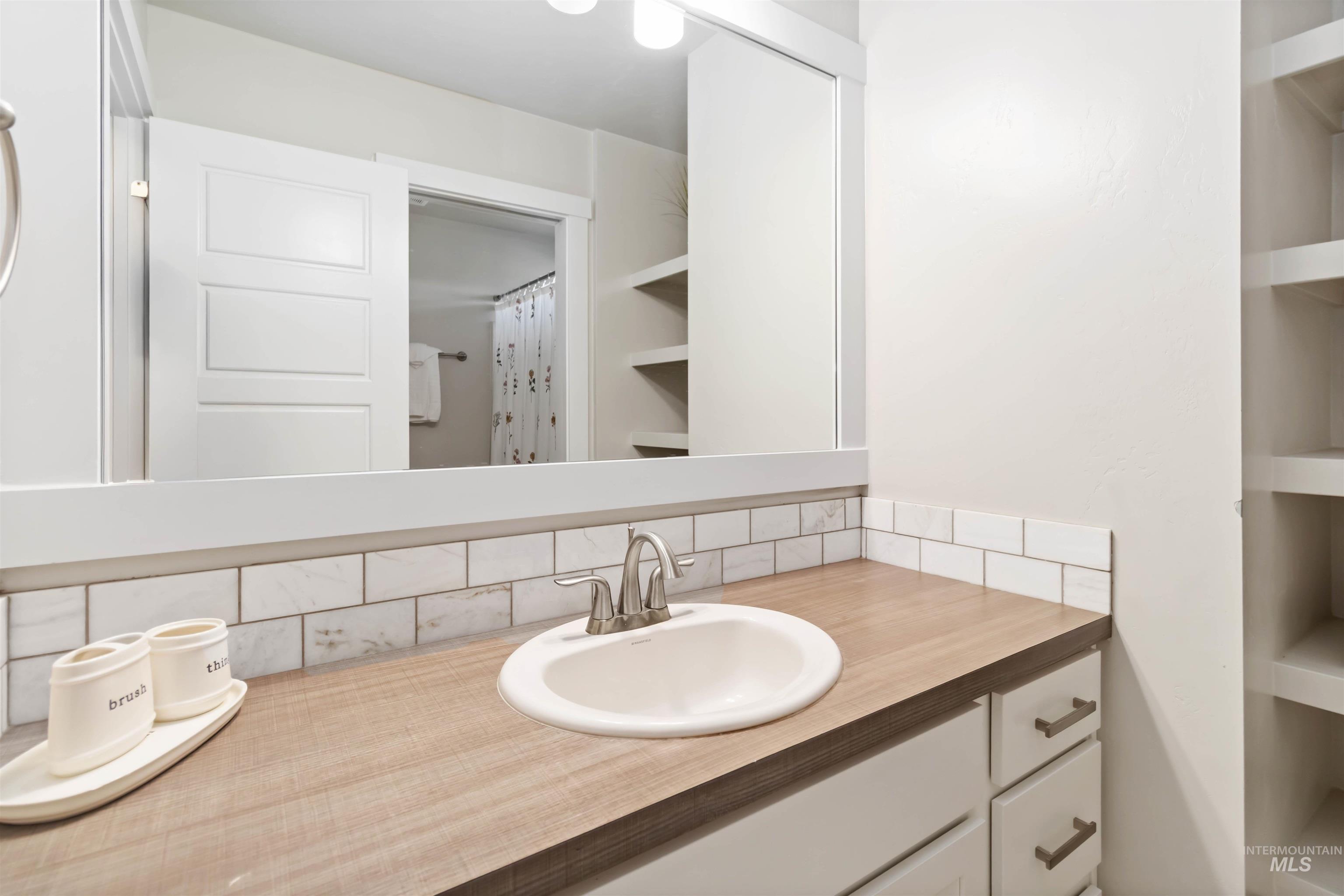 892 North Chastain Lane Eagle, ID 83616 - Photo 32 of 45 Full bathroom featuring tasteful backsplash, vanity, and a shower with curtain