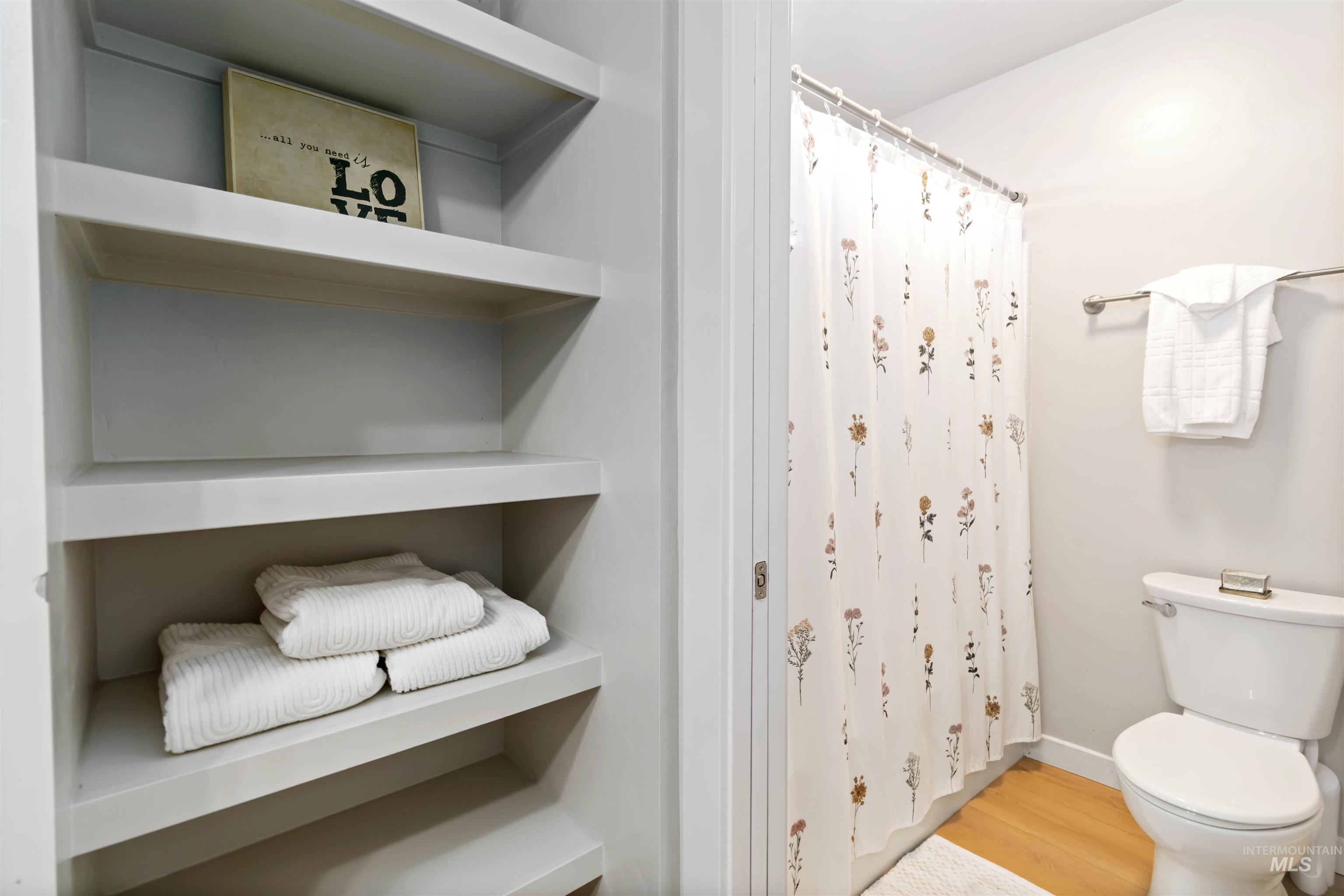 892 North Chastain Lane Eagle, ID 83616 - Photo 33 of 45 Full bathroom featuring wood finished floors and a shower with shower curtain