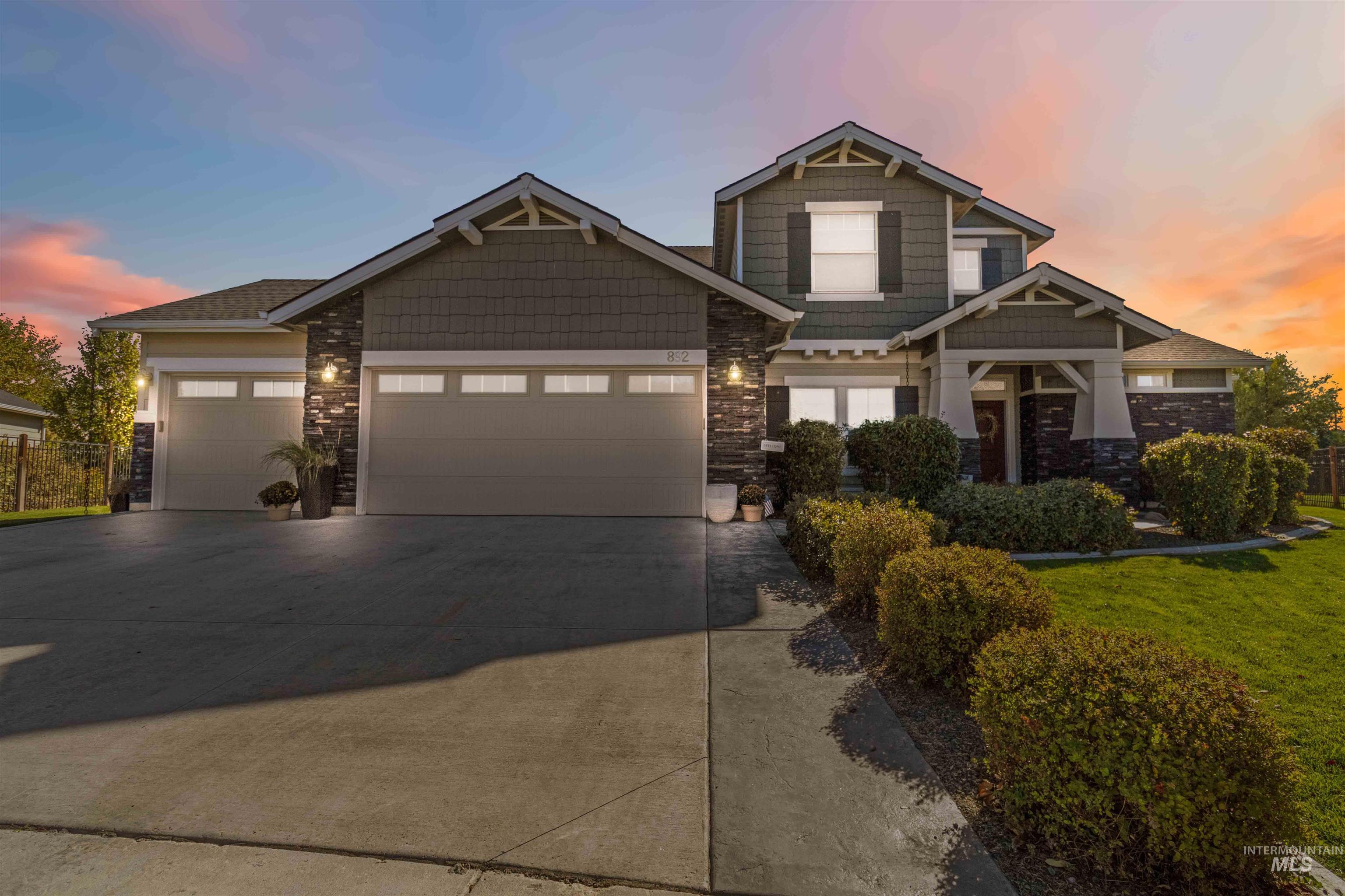 892 North Chastain Lane Eagle, ID 83616 - Photo 43 of 45 Craftsman inspired home with a garage, stone siding, driveway, and a yard