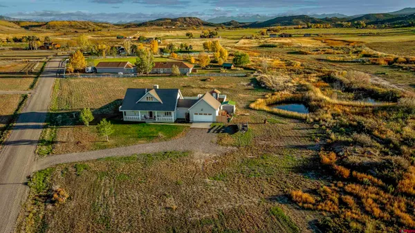 an aerial view of residential houses with outdoor space