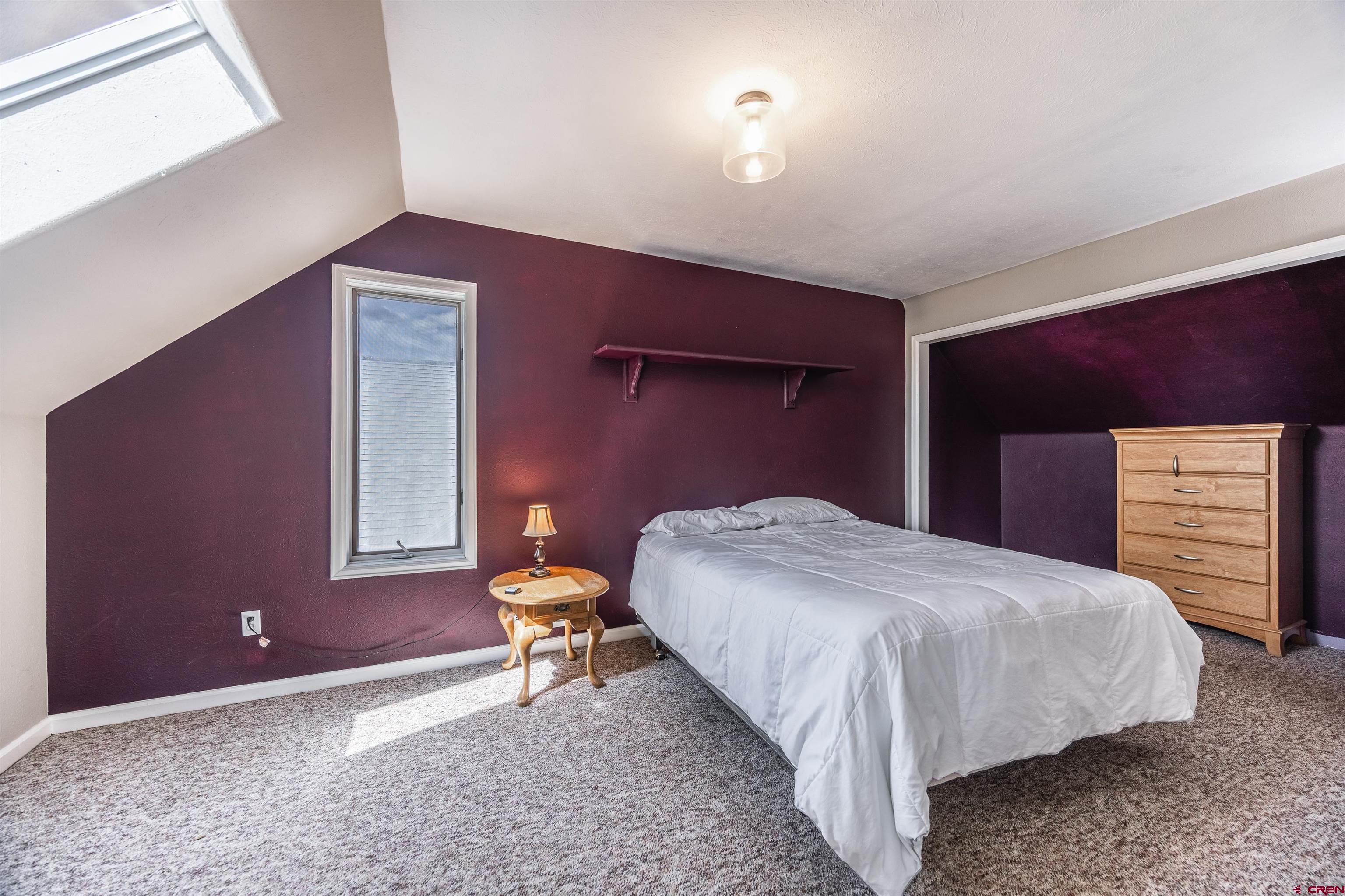 19555 6575th Road Montrose, CO 81403 - Photo 13 of 36 a bedroom with a bed and a chair