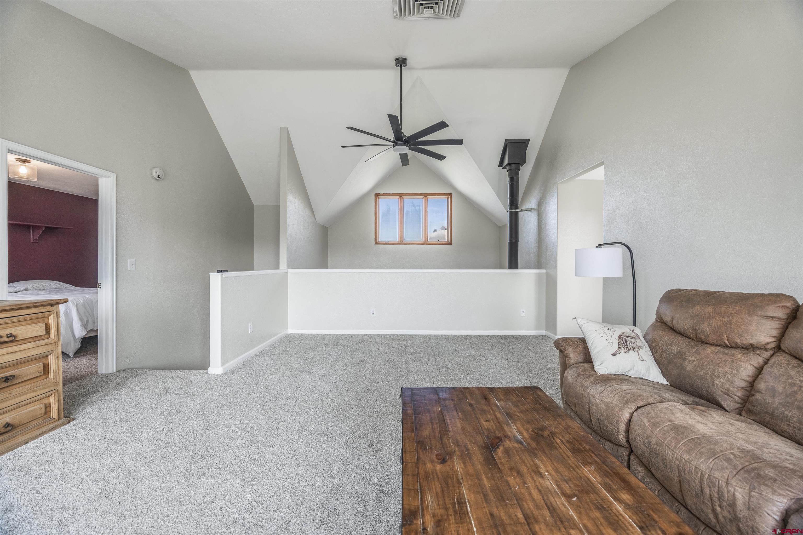 19555 6575th Road Montrose, CO 81403 - Photo 15 of 36 a living room with furniture and a ceiling fan