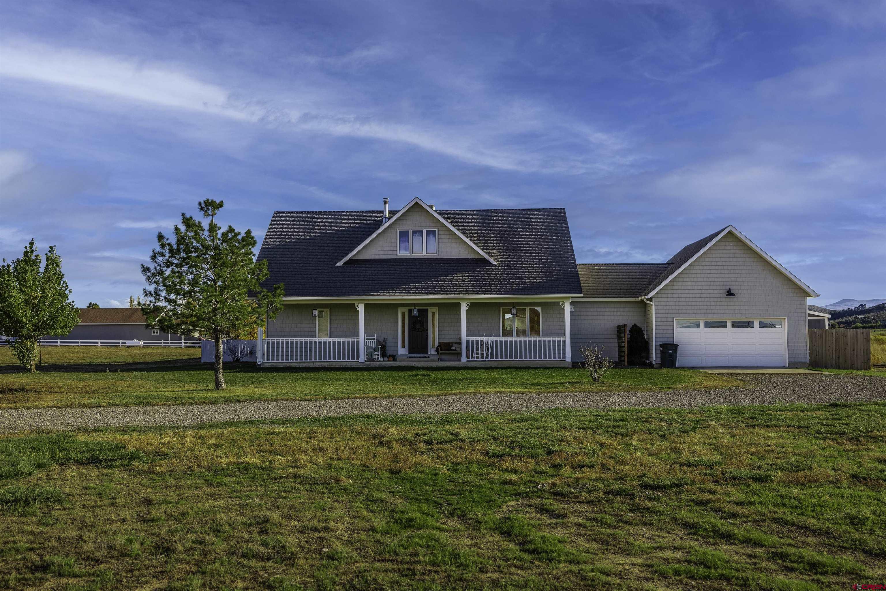 19555 6575th Road Montrose, CO 81403 - Photo 2 of 36 a front view of a house with a yard