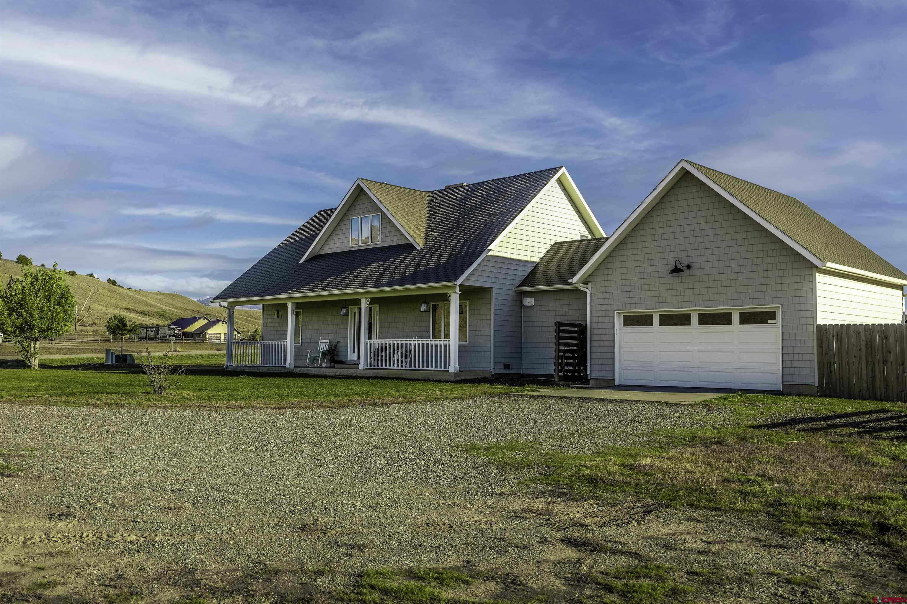 19555 6575th Road Montrose, CO 81403 - Photo 23 of 36 a front view of a house with a yard