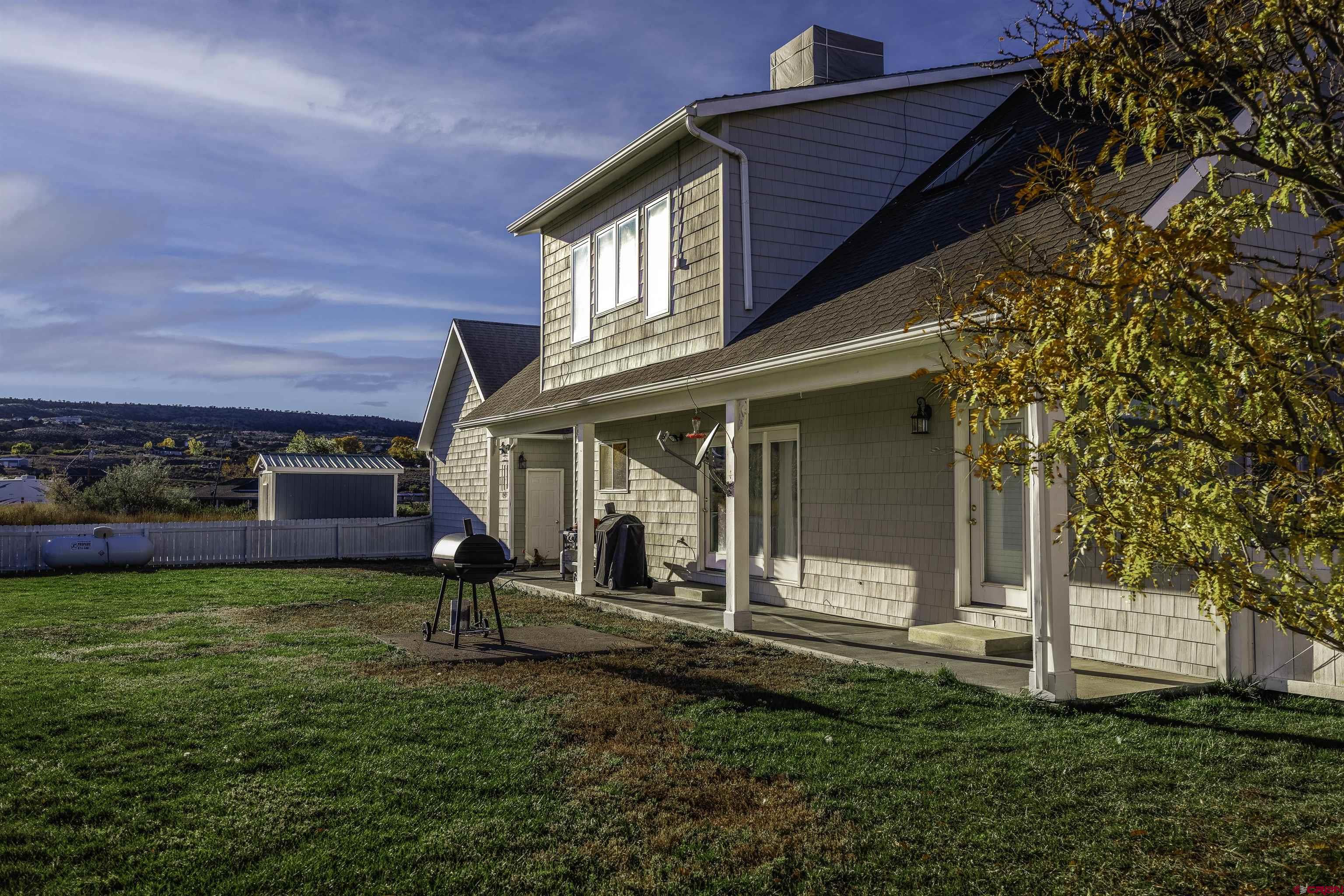 19555 6575th Road Montrose, CO 81403 - Photo 24 of 36 a view of a house with a yard porch and sitting area