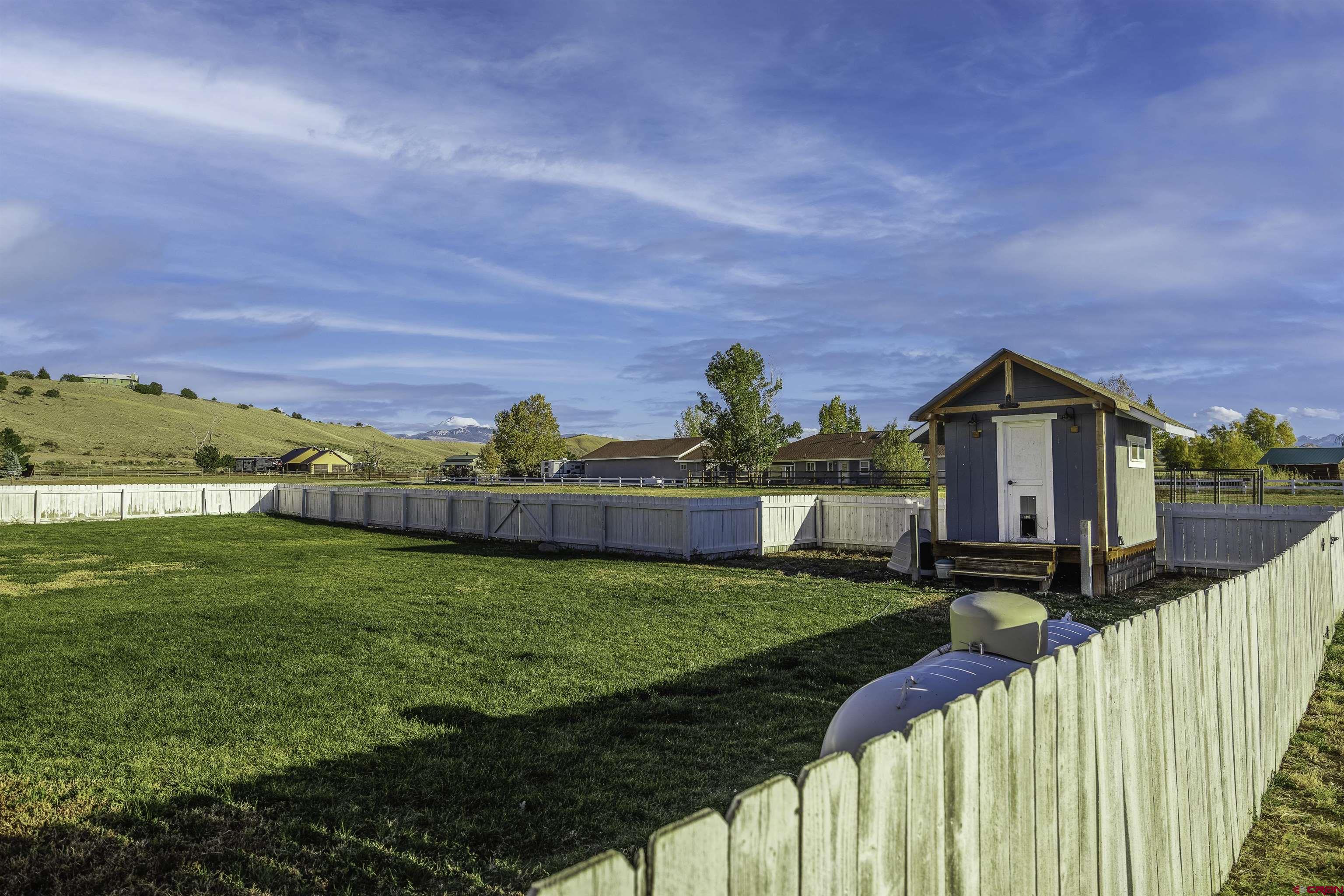 19555 6575th Road Montrose, CO 81403 - Photo 25 of 36 a view of a house with backyard and porch