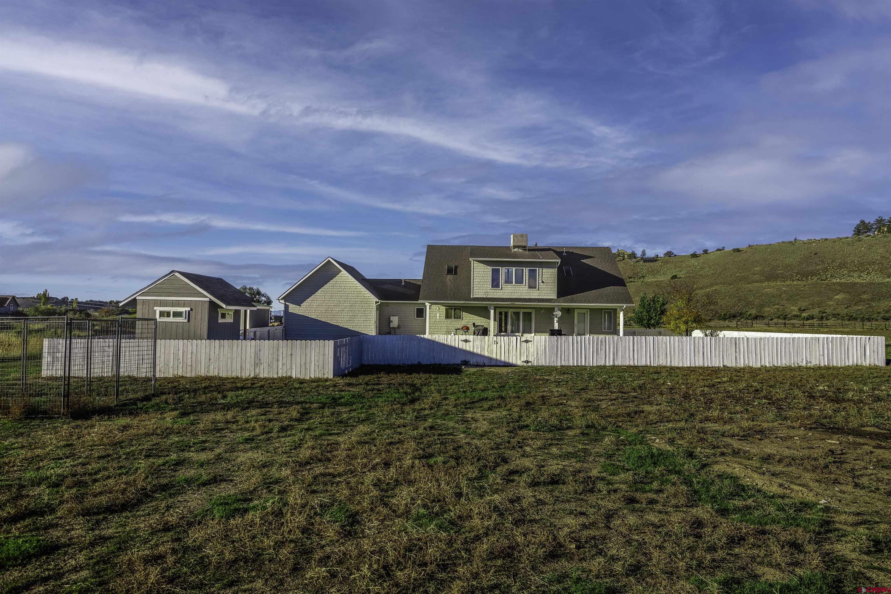 19555 6575th Road Montrose, CO 81403 - Photo 26 of 36 a front view of a house with a yard
