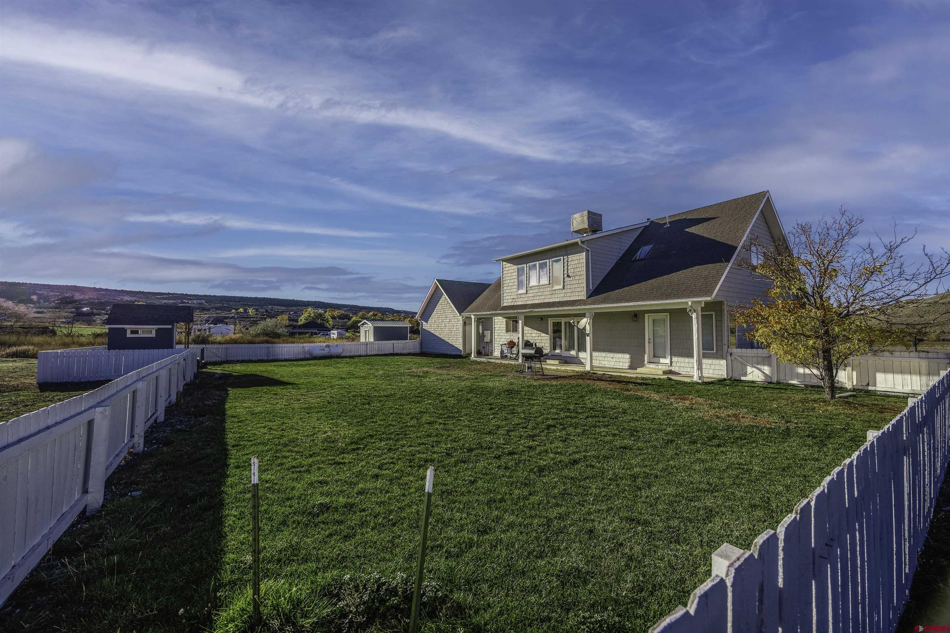 19555 6575th Road Montrose, CO 81403 - Photo 29 of 36 a view of a house with a yard